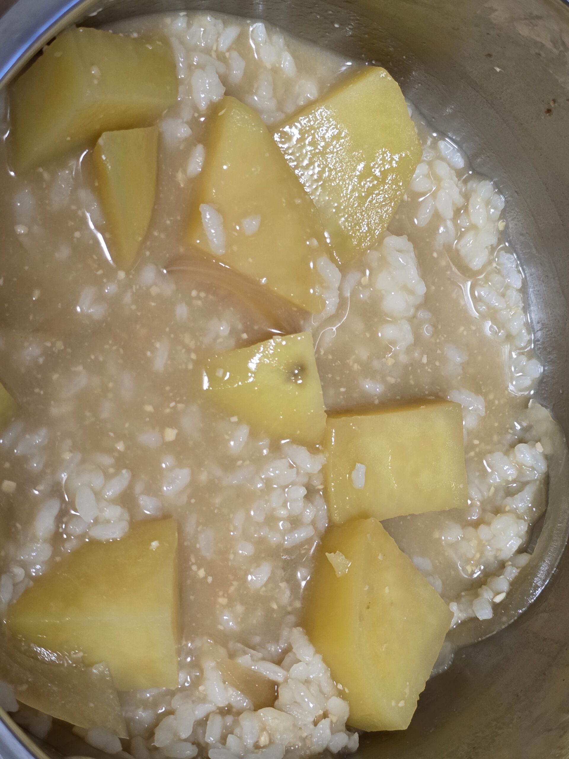 Miso soup with potatoes served with rice.