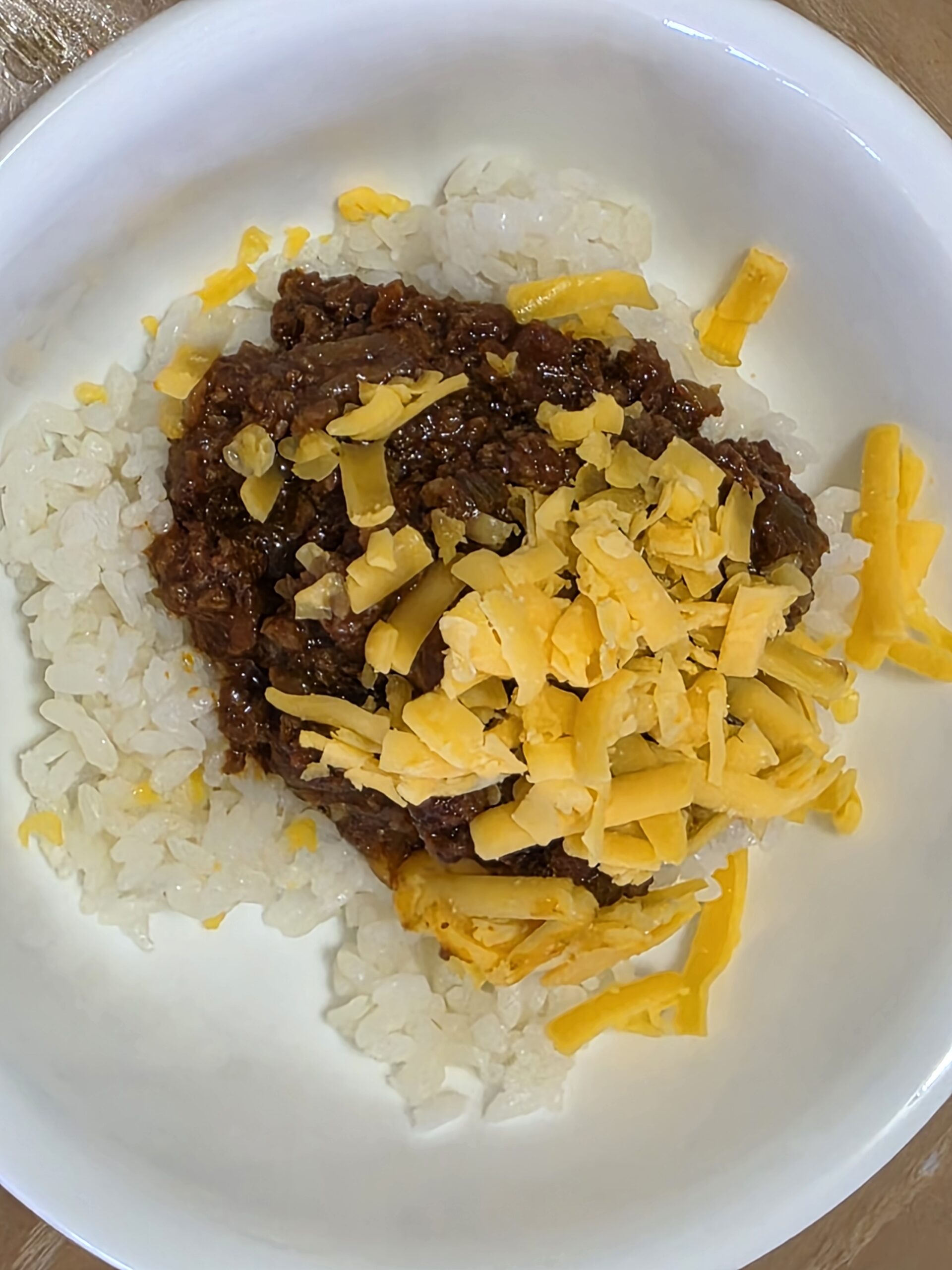 Chili served with rice, made by turning leftover meat sauce into chili.