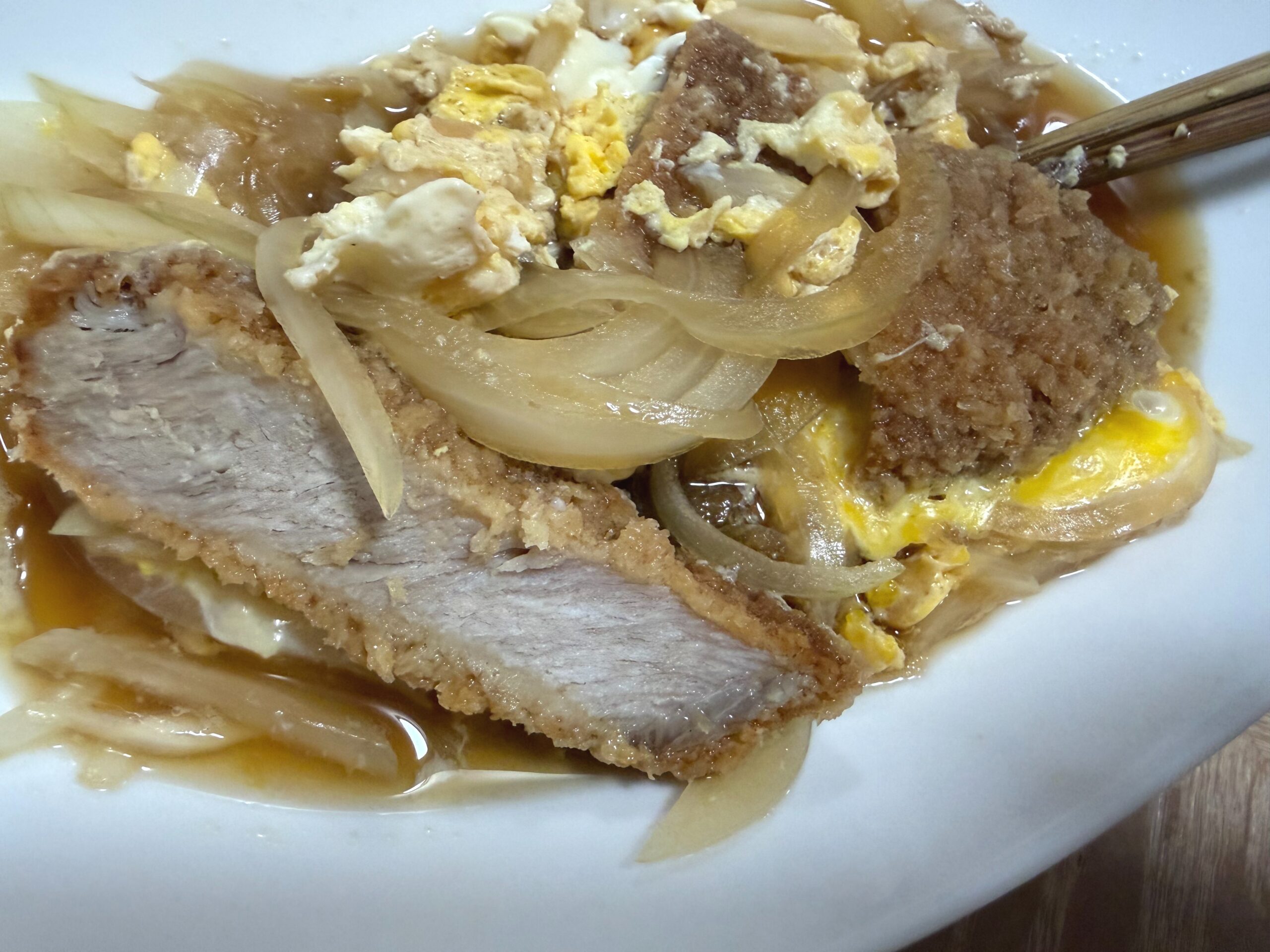 Katsudon with pork cutlet, egg, and rice served for dinner.
