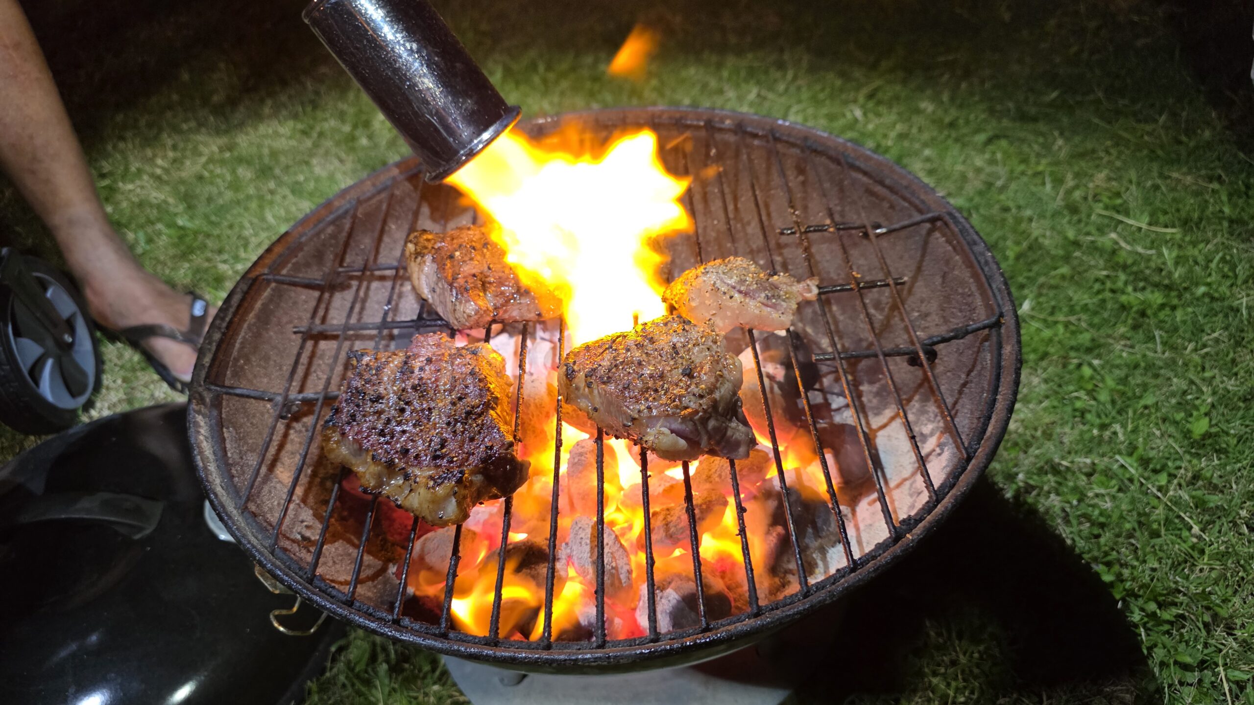 Tri-tip steak cooking during a camping barbecue.